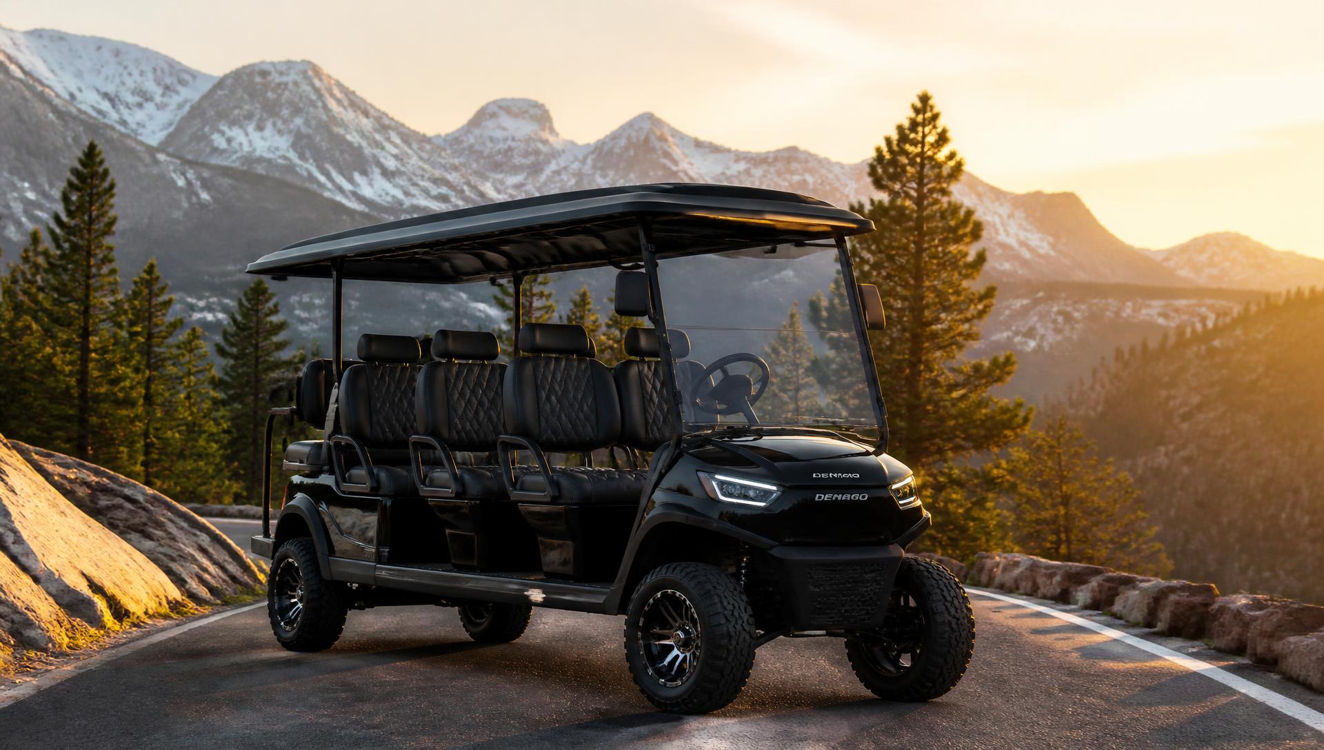 Black six-passenger electric golf cart on a mountain road at sunrise